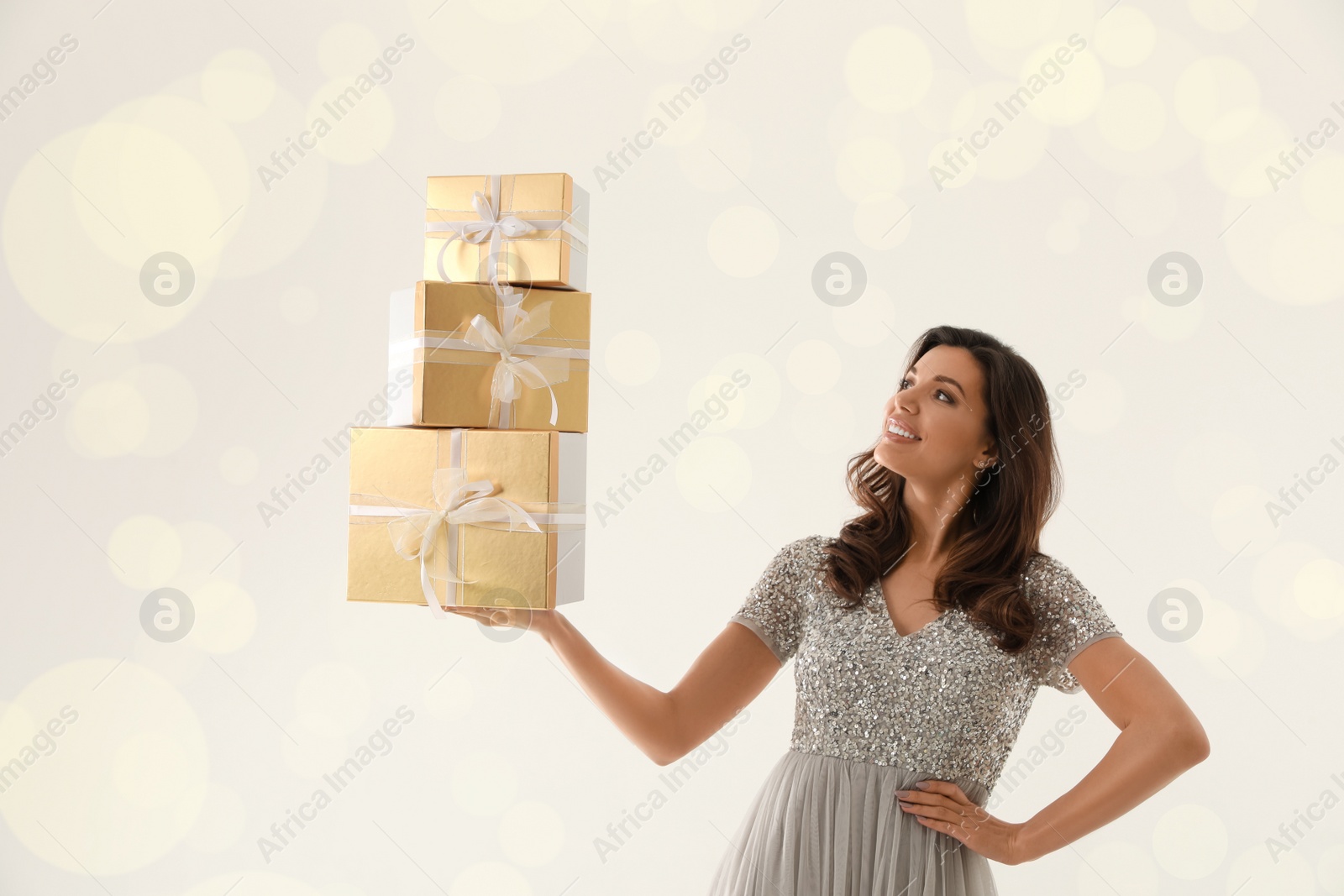 Photo of Beautiful woman with Christmas gifts on white background