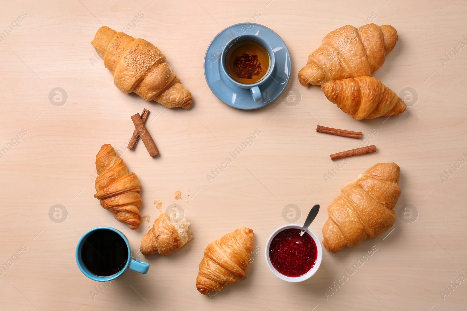 Photo of Flat lay composition with tasty croissants on wooden background