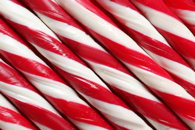 Photo of Candy canes as background, closeup. Traditional Christmas treat