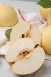 Photo of Delicious apple pears on white marble table, closeup