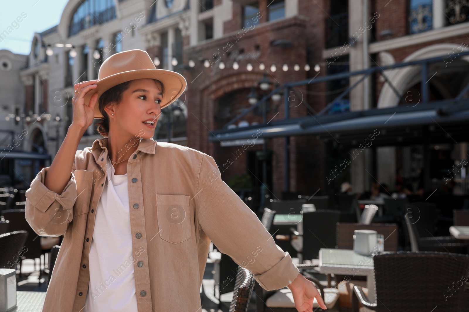 Photo of Portrait of happy young woman on city street