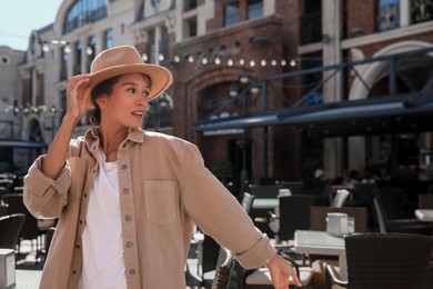 Photo of Portrait of happy young woman on city street