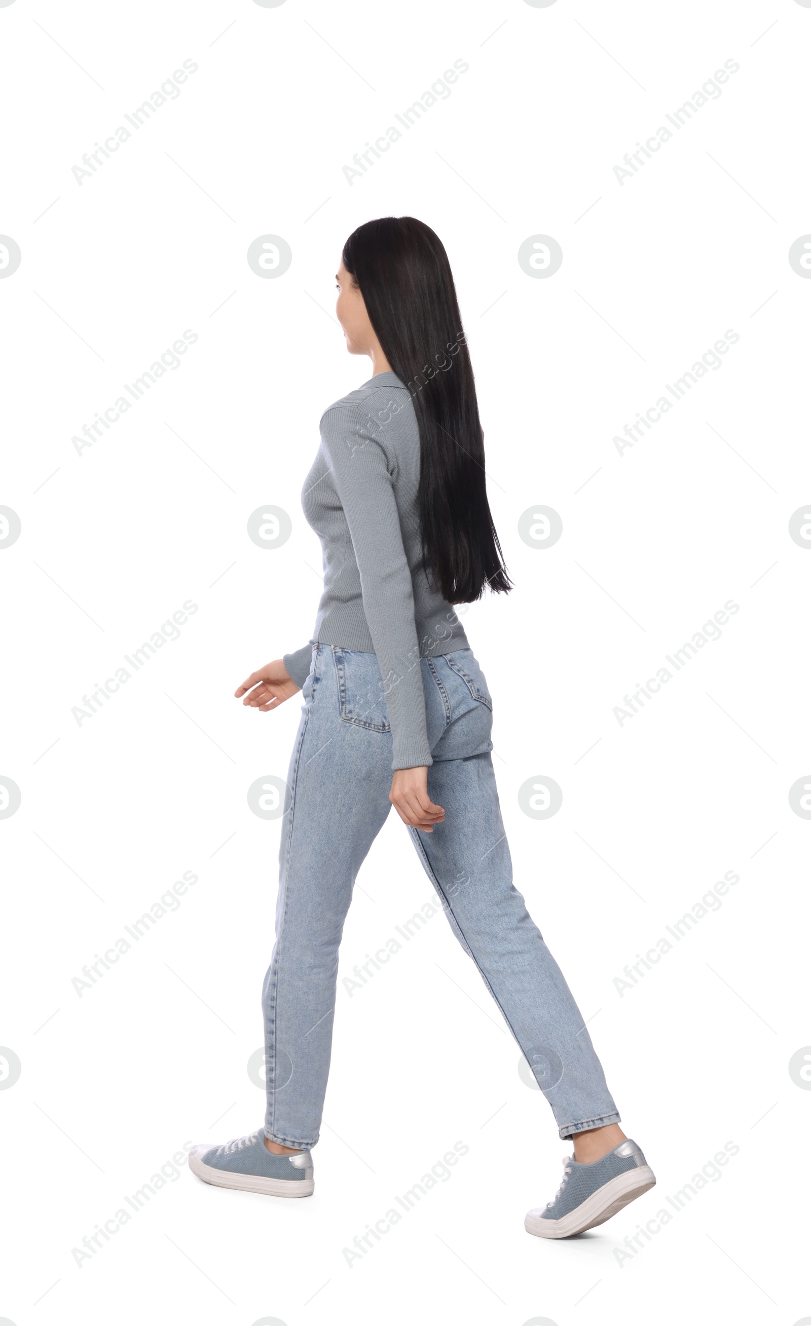 Photo of Woman in casual outfit walking on white background