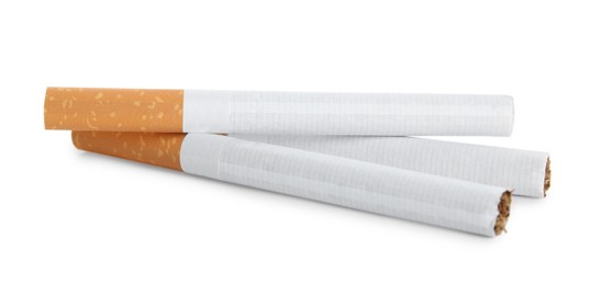 Photo of Cigarettes with orange filters isolated on white