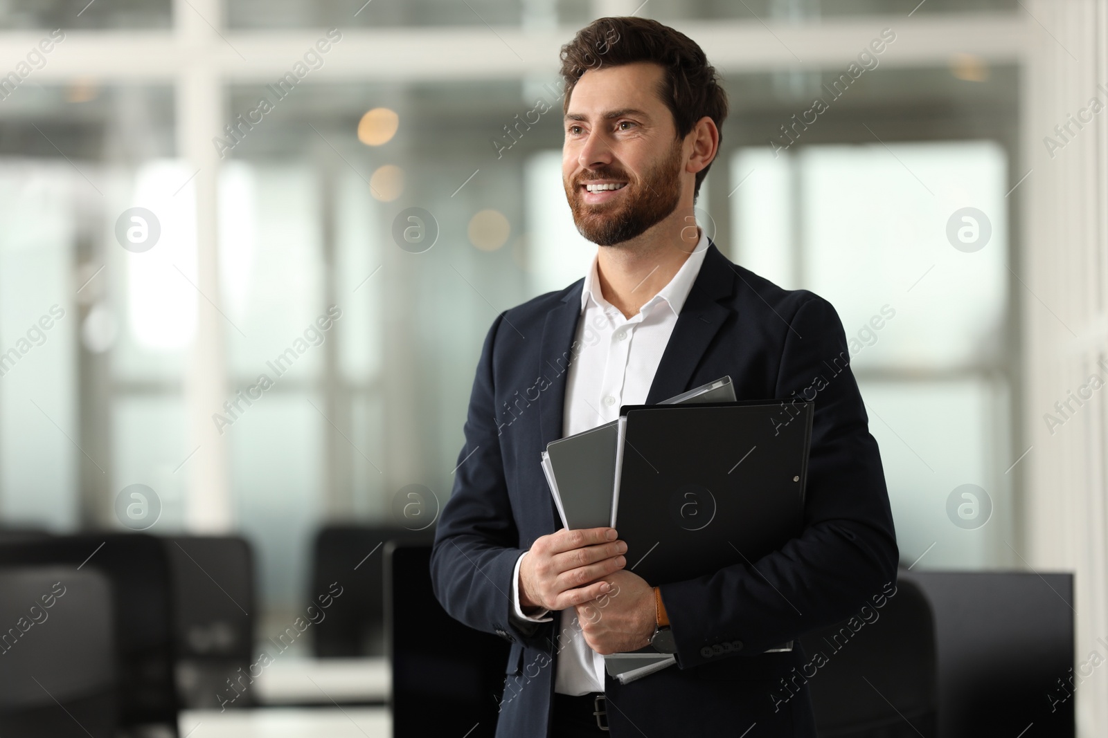 Photo of Smiling man with folders in office, space for text. Lawyer, businessman, accountant or manager