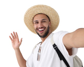 Smiling young man in straw hat taking selfie on white background