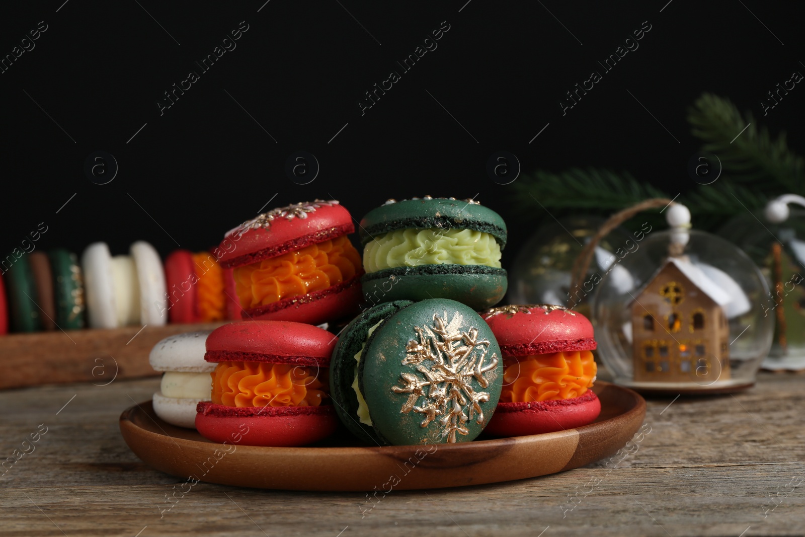 Photo of Beautifully decorated Christmas macarons and festive decor on wooden table