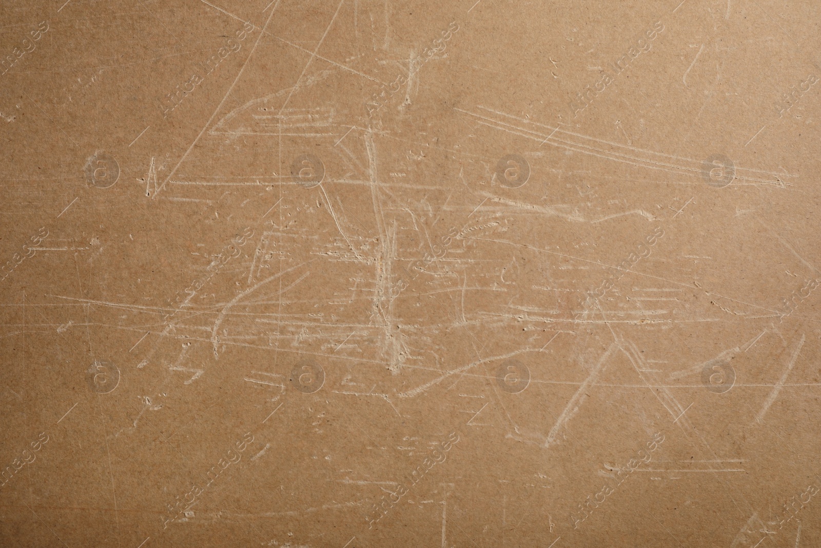 Photo of Old fiberboard with scratches as background, closeup