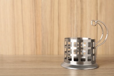 Photo of Traditional tea glass holder on wooden table, space for text