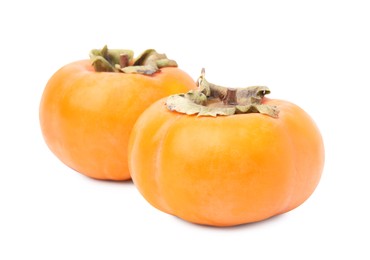 Whole delicious juicy persimmons on white background