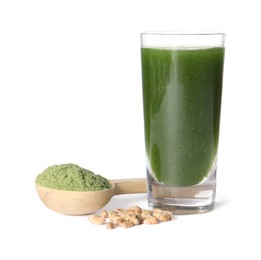 Photo of Wheat grass drink in shot glass, seeds and spoon of green powder isolated on white
