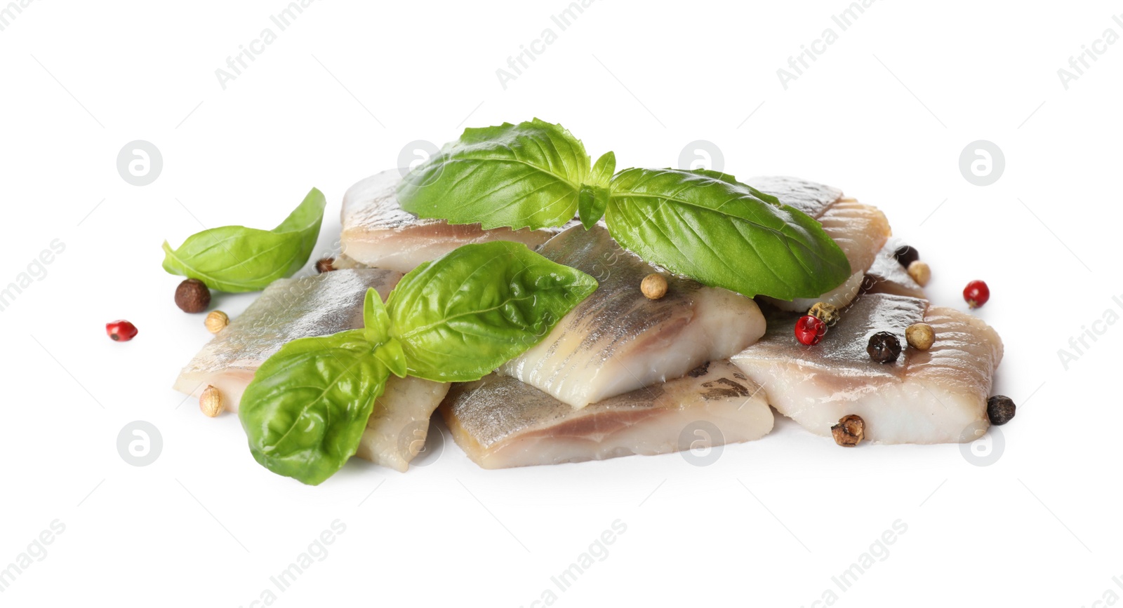 Photo of Delicious salted herring slices with basil and peppercorns on white background