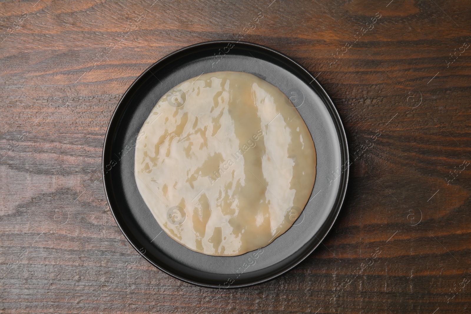 Photo of Making kombucha. Scoby fungus on wooden table, top view