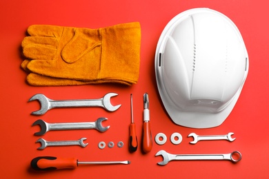 Photo of Flat lay composition with construction tools on color background