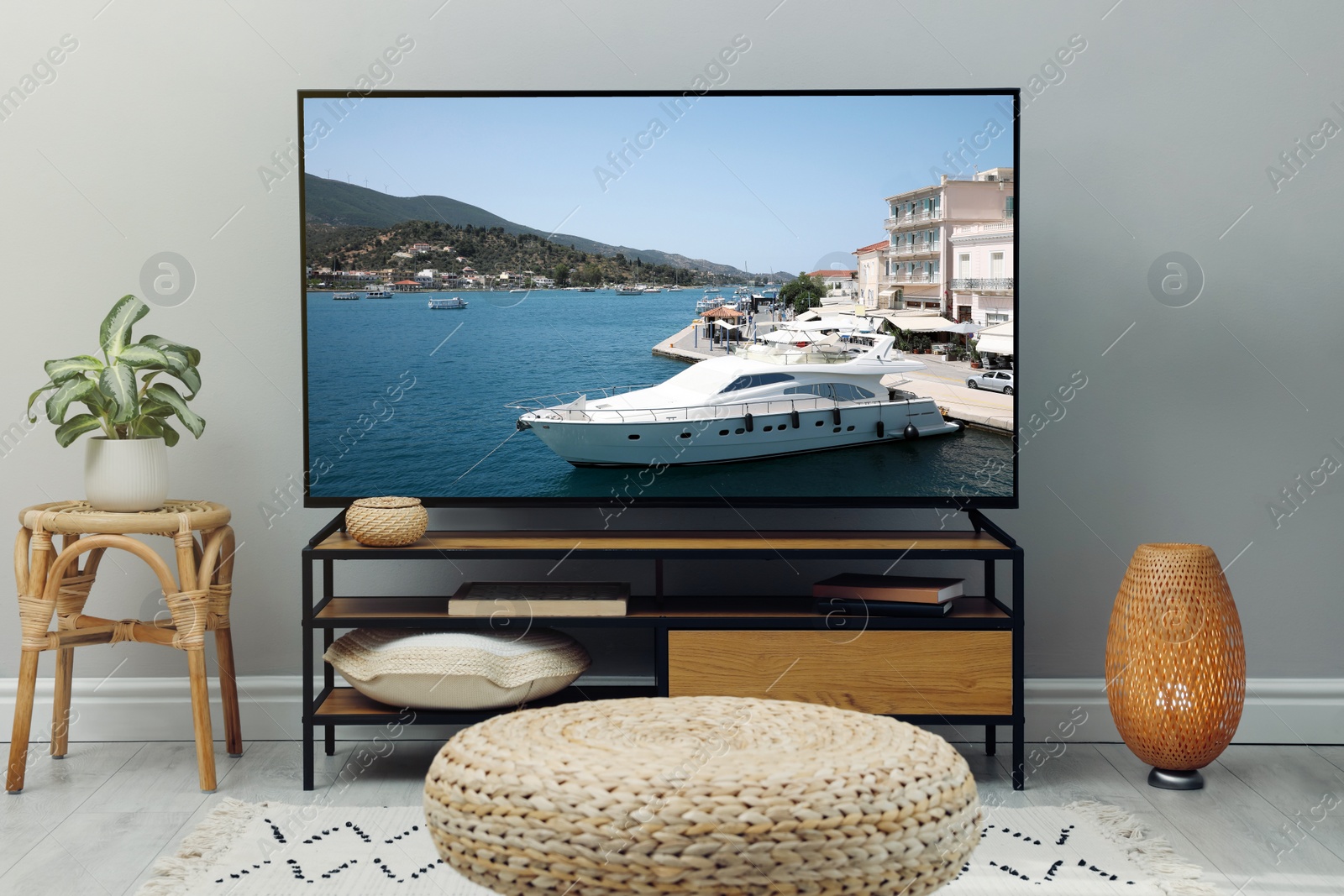 Image of Modern TV set on wooden stand in room