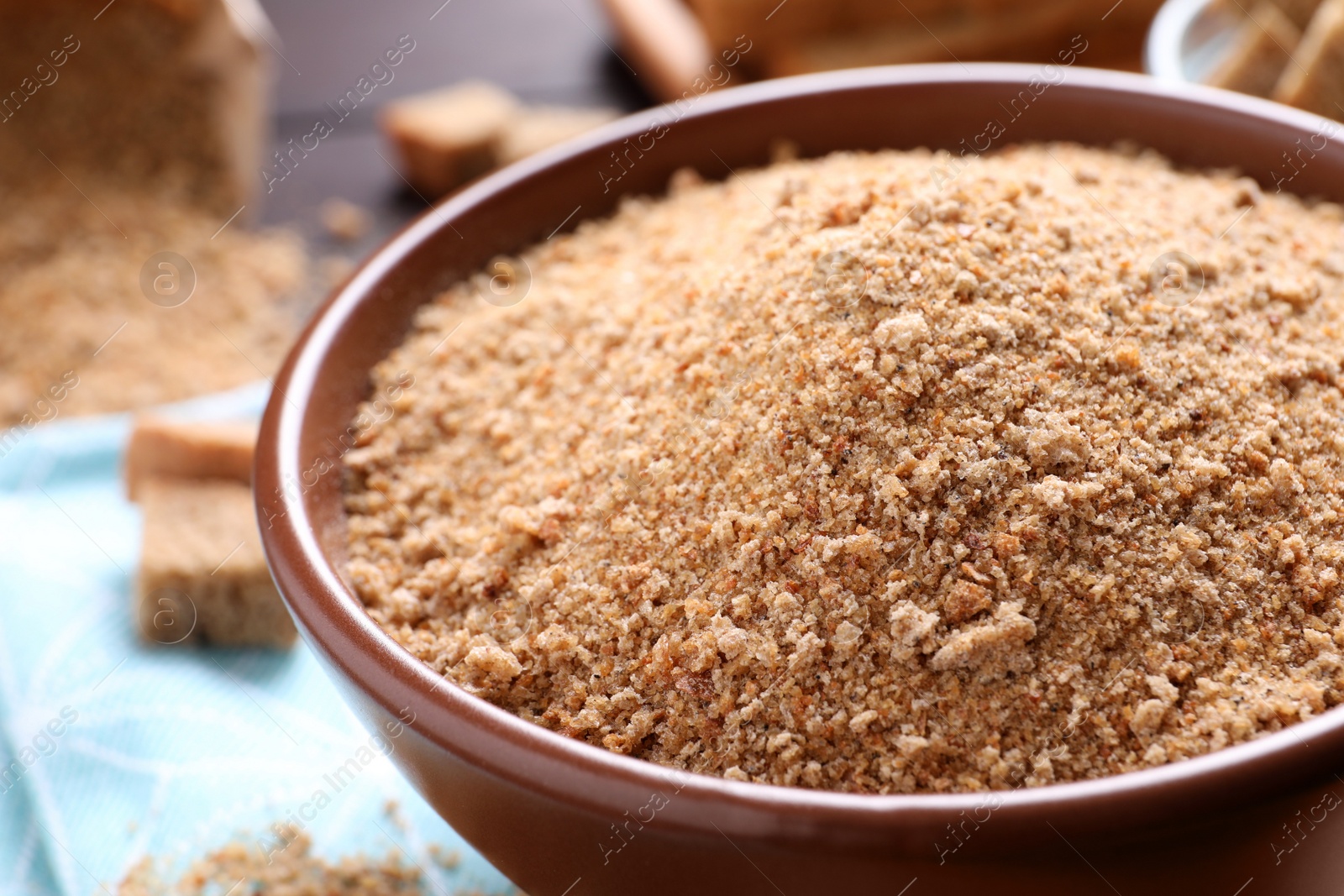 Photo of Fresh breadcrumbs in bowl on table, closeup