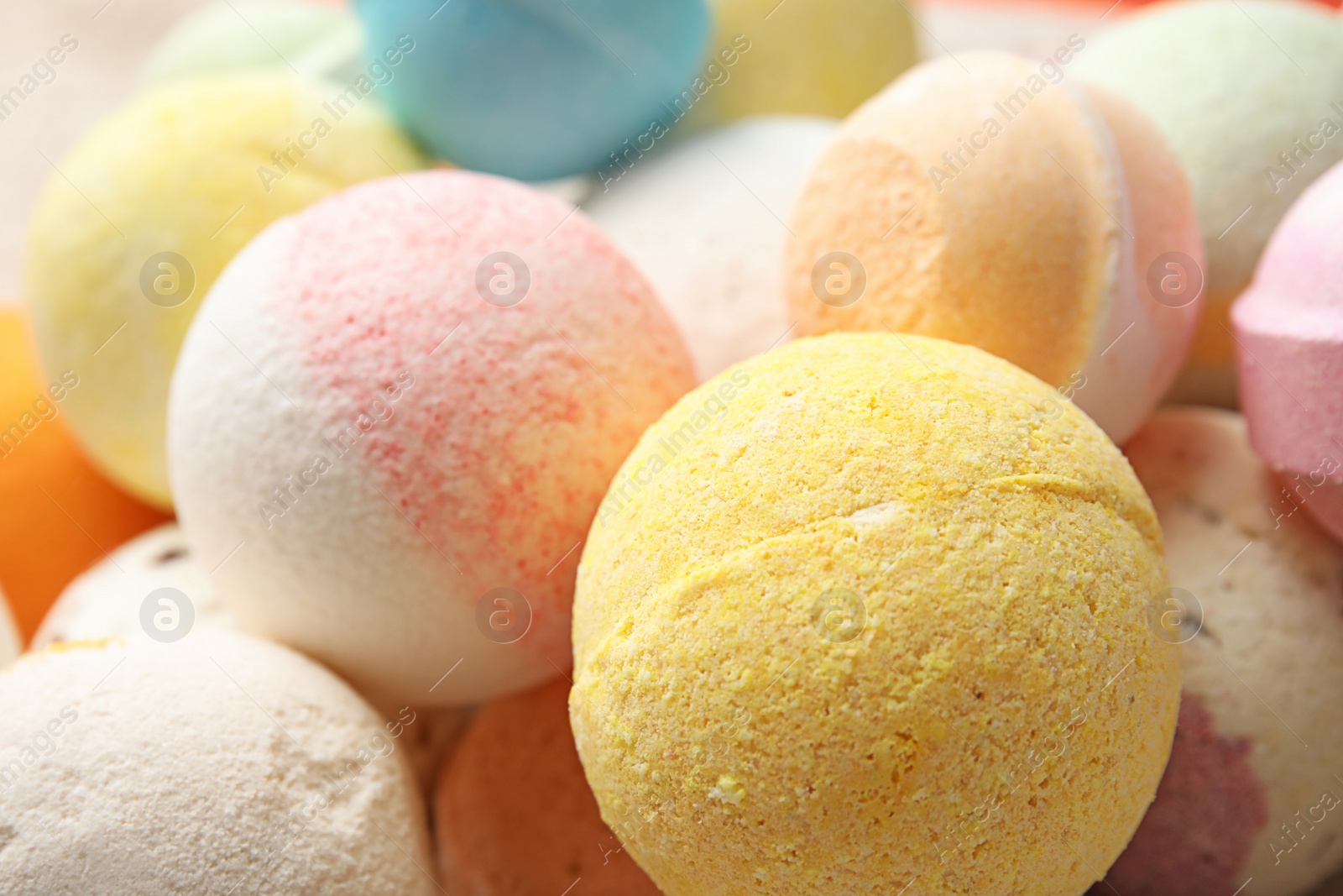 Photo of Many bath bombs as background, closeup view