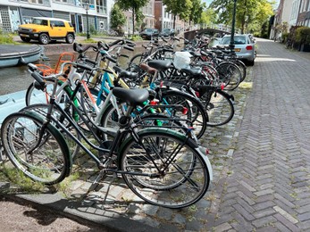 Photo of Parking with different bicycles on city street