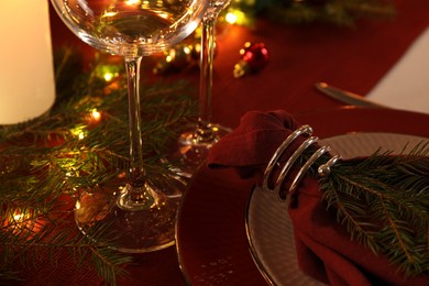 Photo of Christmas place setting with festive decor on table, closeup