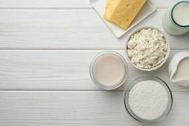 Photo of Lactose free dairy products on white wooden table, flat lay. Space for text