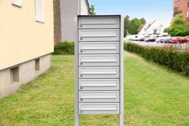 Photo of Metal letter boxes near apartment building outdoors