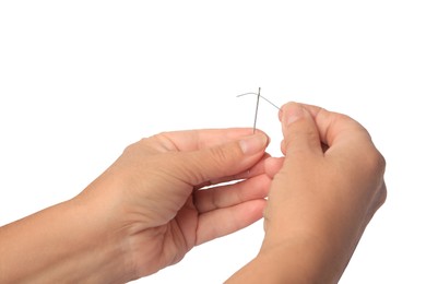 Closeup view of woman threading needle on white background