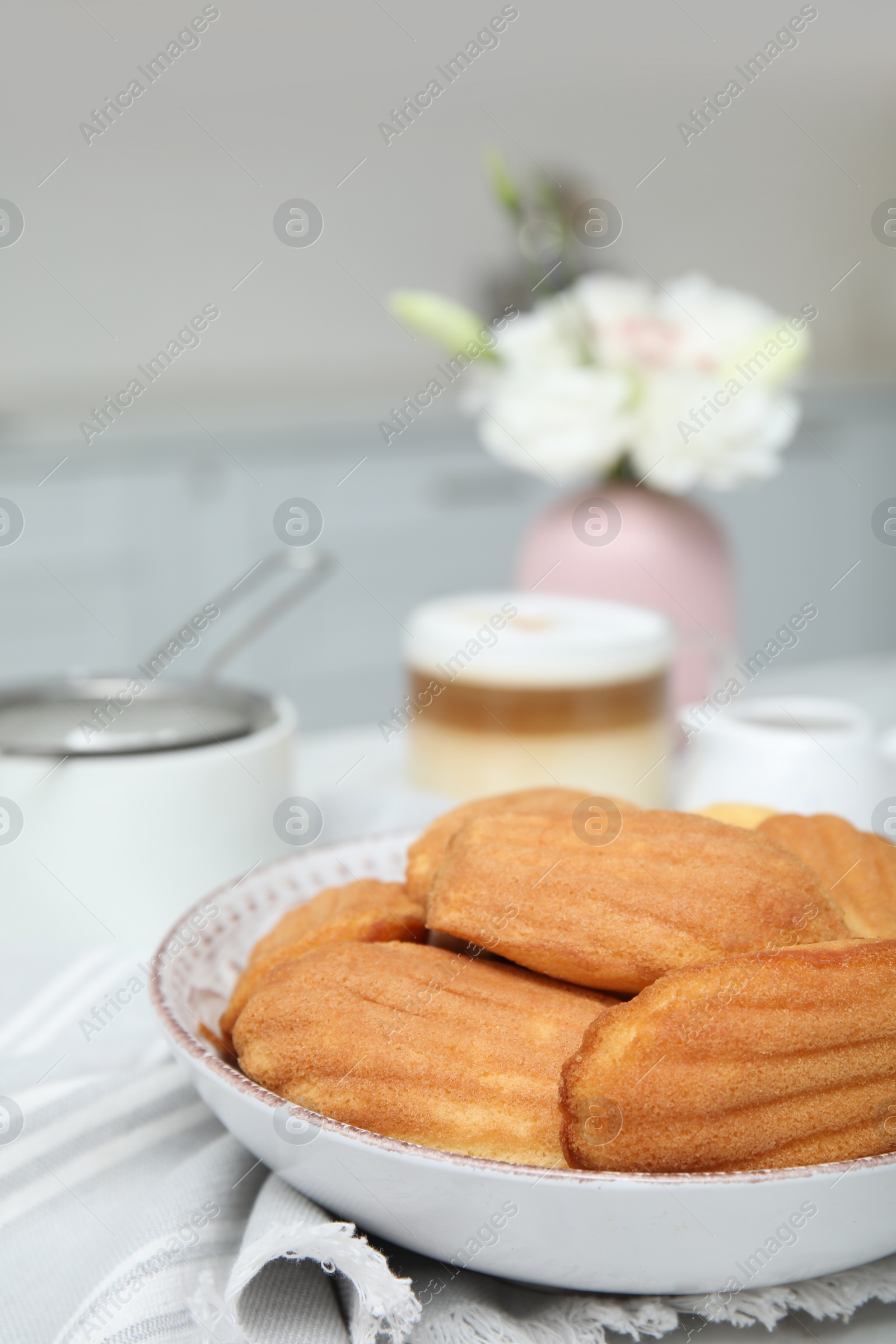 Photo of Tasty madeleine cookies on table in kitchen