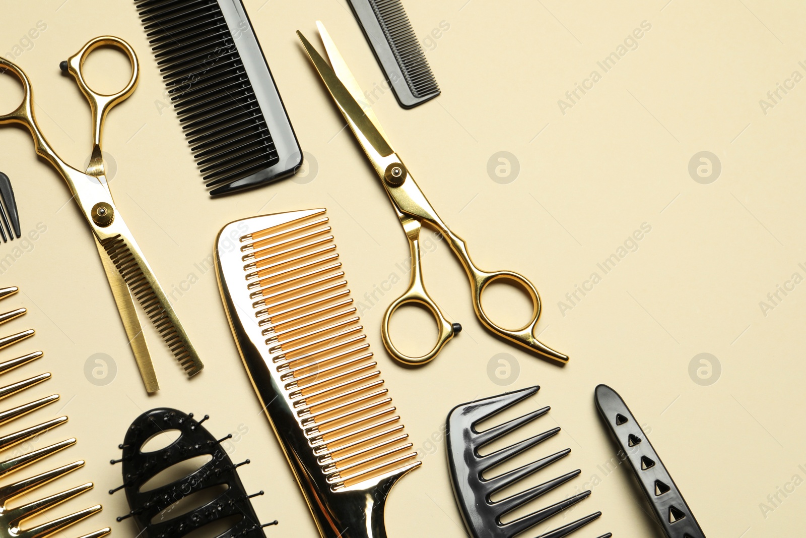 Photo of Hairdressing tools on beige background, flat lay. Space for text