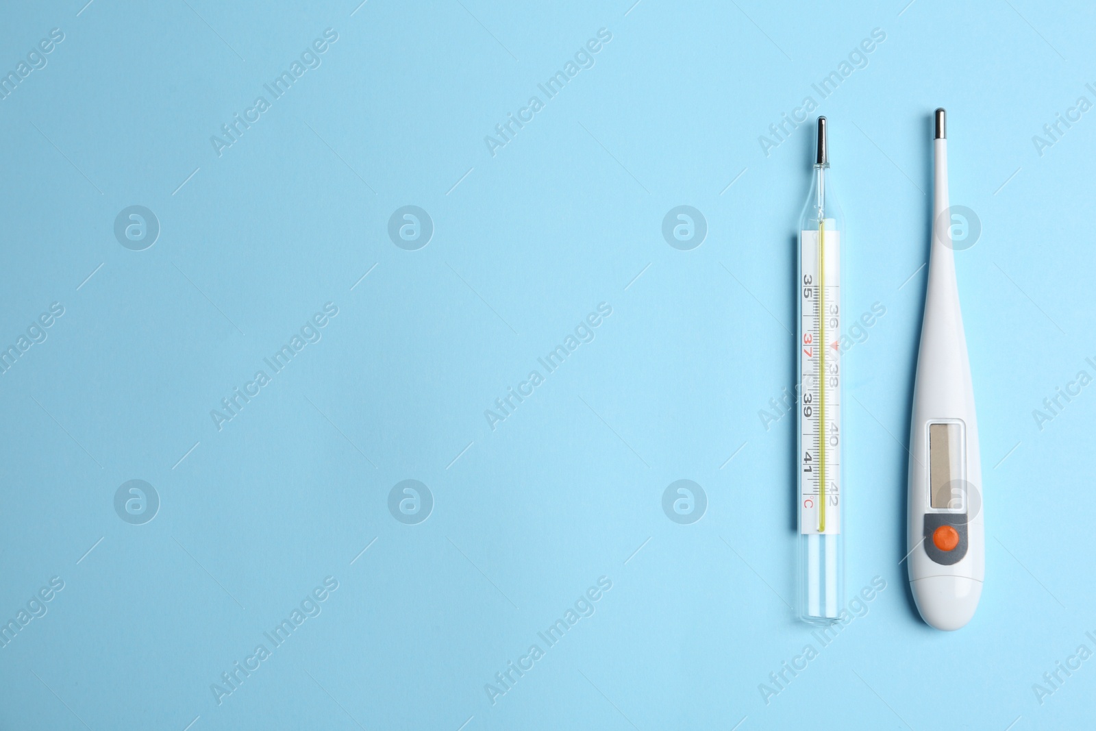 Photo of Different thermometers on light blue background, flat lay. Space for text