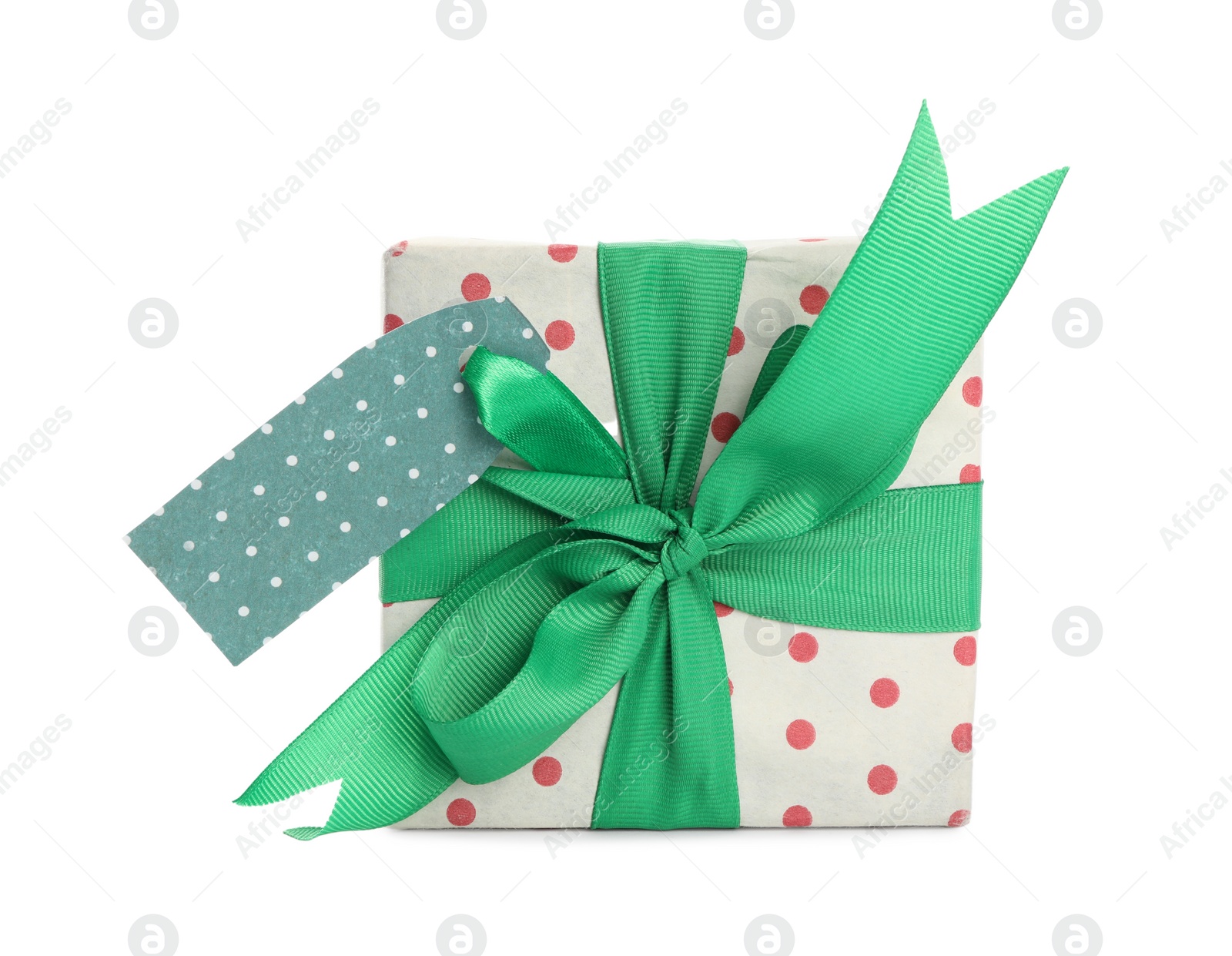 Photo of Christmas gift box with green bow and tag isolated on white