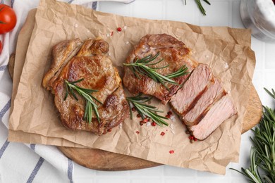 Photo of Delicious fried meat with rosemary on white table, flat lay