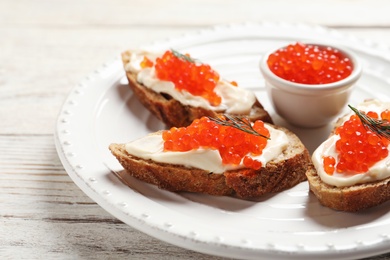 Photo of Sandwiches with red caviar on plate