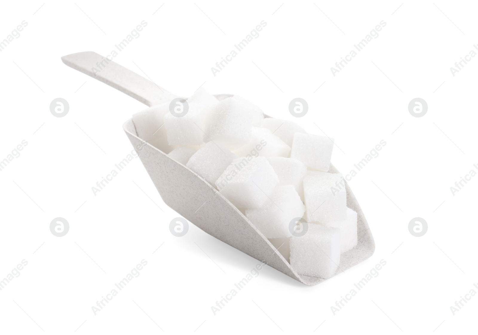 Photo of Sugar cubes in scoop isolated on white