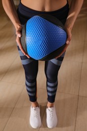 Photo of Woman with medicine ball in gym, closeup