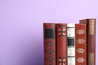 Collection of old books on violet background