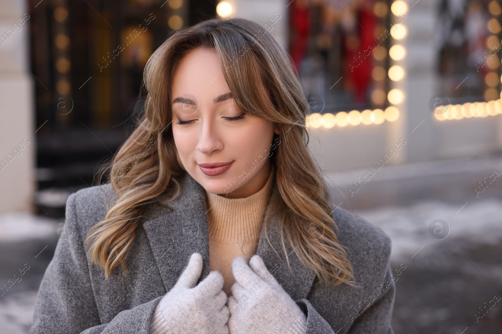 Photo of Portrait of charming woman on city street in winter