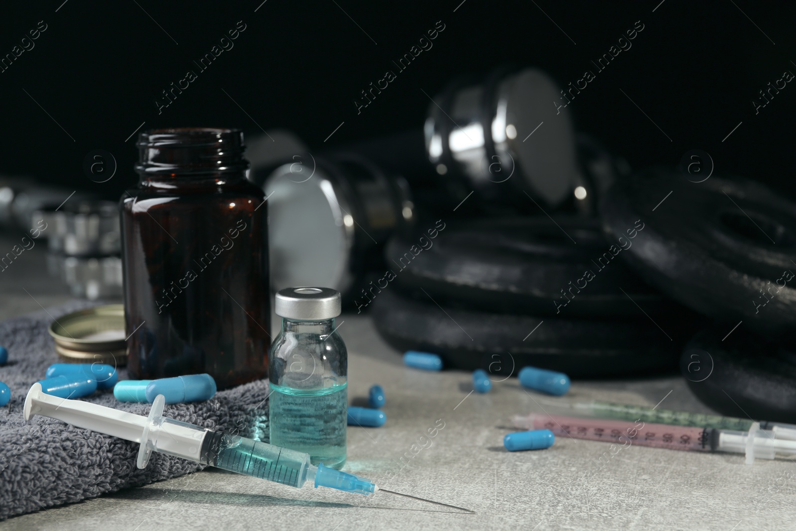 Photo of Different drugs and sports equipment on table. Doping control