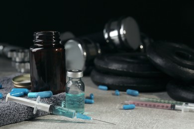 Different drugs and sports equipment on table. Doping control