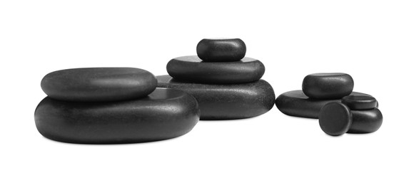 Many stacked black stones isolated on white