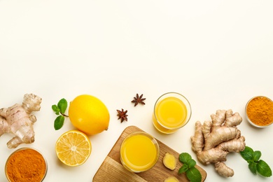 Photo of Immunity boosting drink and ingredients on white background, flat lay. Space for text