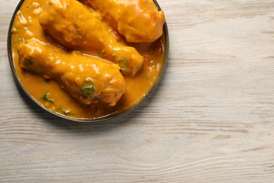 Tasty chicken curry on wooden table, top view. Space for text