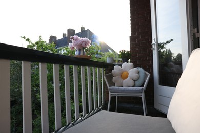 Photo of Different plants on railings and chair at cozy balcony outdoors