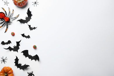 Halloween decor elements on white background, flat lay. Space for text