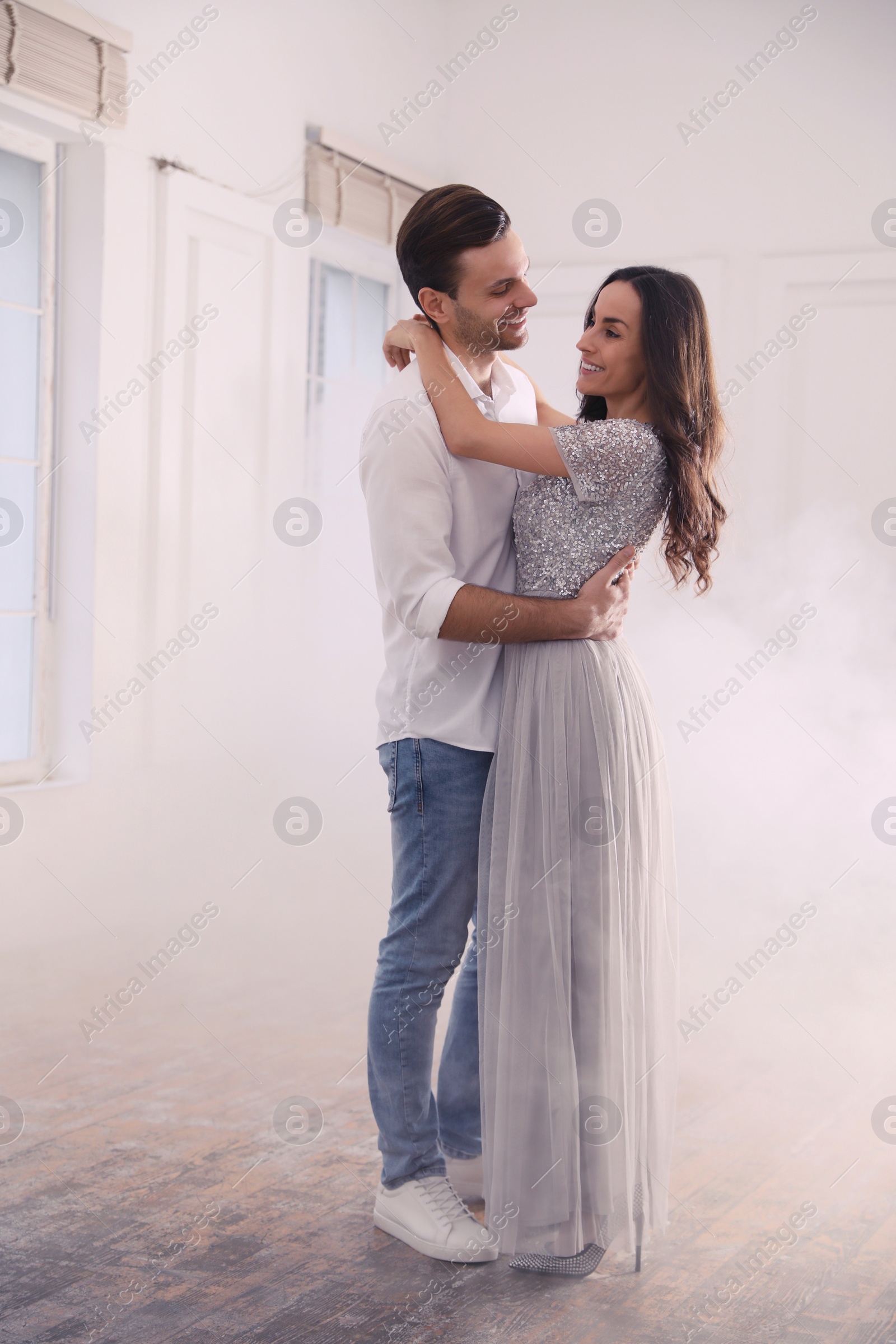 Photo of Lovely young couple dancing together in ballroom