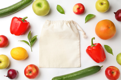 Photo of Cotton eco bag, fruits and vegetables on white background, top view