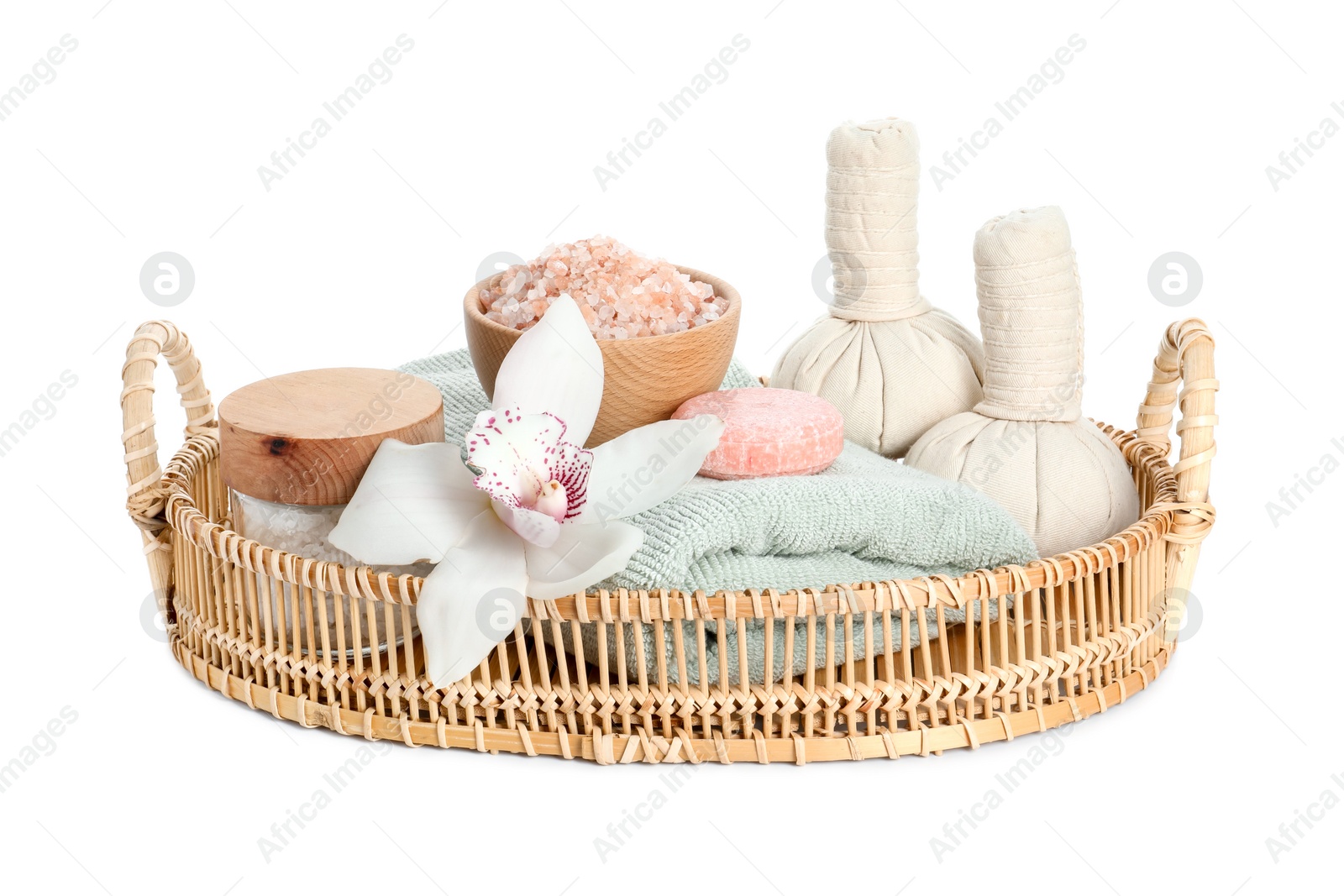 Photo of Spa composition. Towel, herbal massage bags, sea salt, soap and beautiful flower on white background