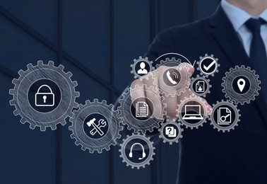 Image of Business process. Man touching virtual screen with different icons, closeup