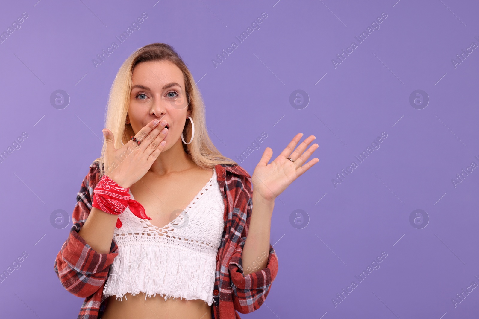 Photo of Portrait of beautiful hippie woman on purple background. Space for text