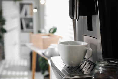 Photo of Modern coffee machine with cup in office. Space for text