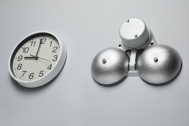 Photo of Modern electrical school bell and clock on white wall